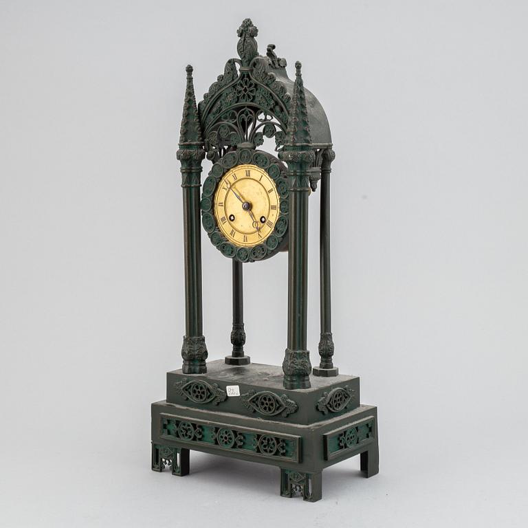 A cast iron gothic revival mantel clock, late 19th century.