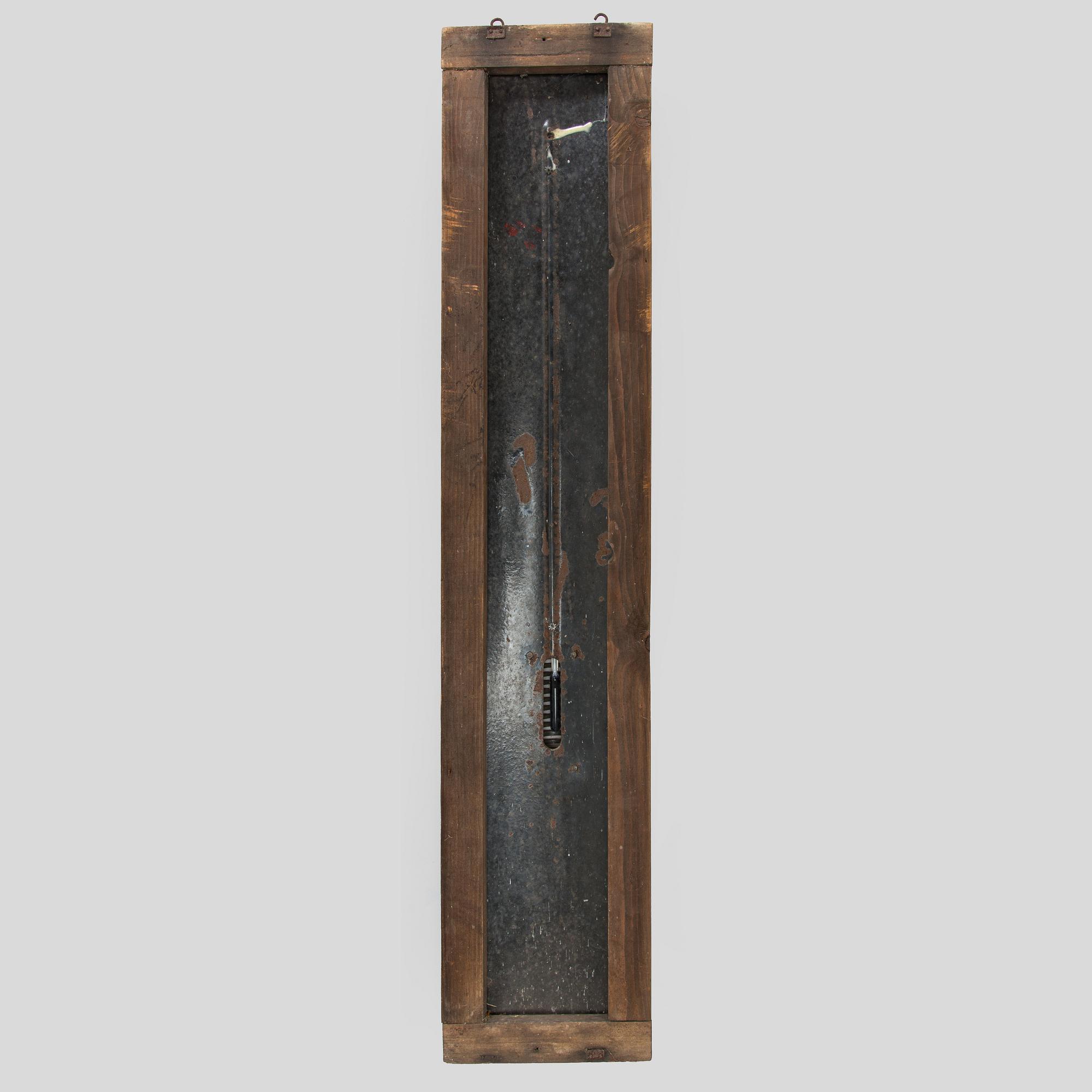 a mid-20th century outdoor thermometer.