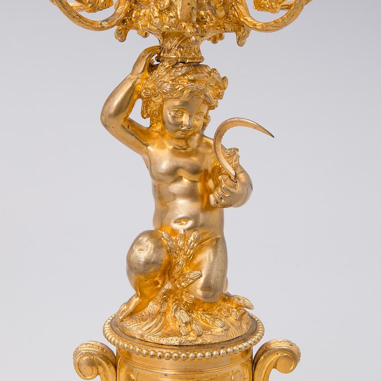 Two similar mid 19th century candelabra in gilt bronze,