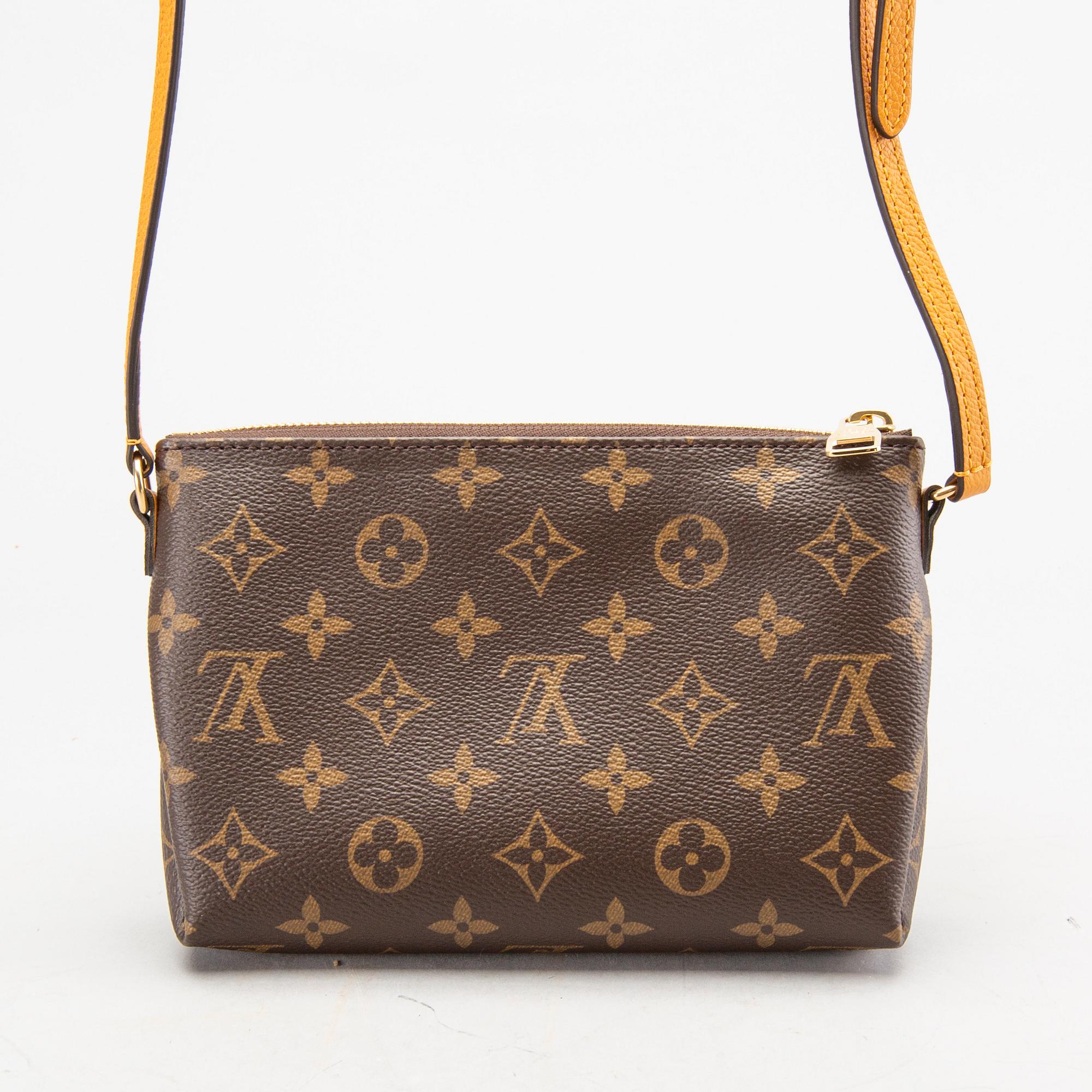 A Louis Vuitton Pallas clutch.