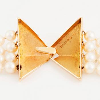 Kristian Nilsson, a four strand cultured pearl necklace with an 18K gold clasp, , Stockholm 1985.