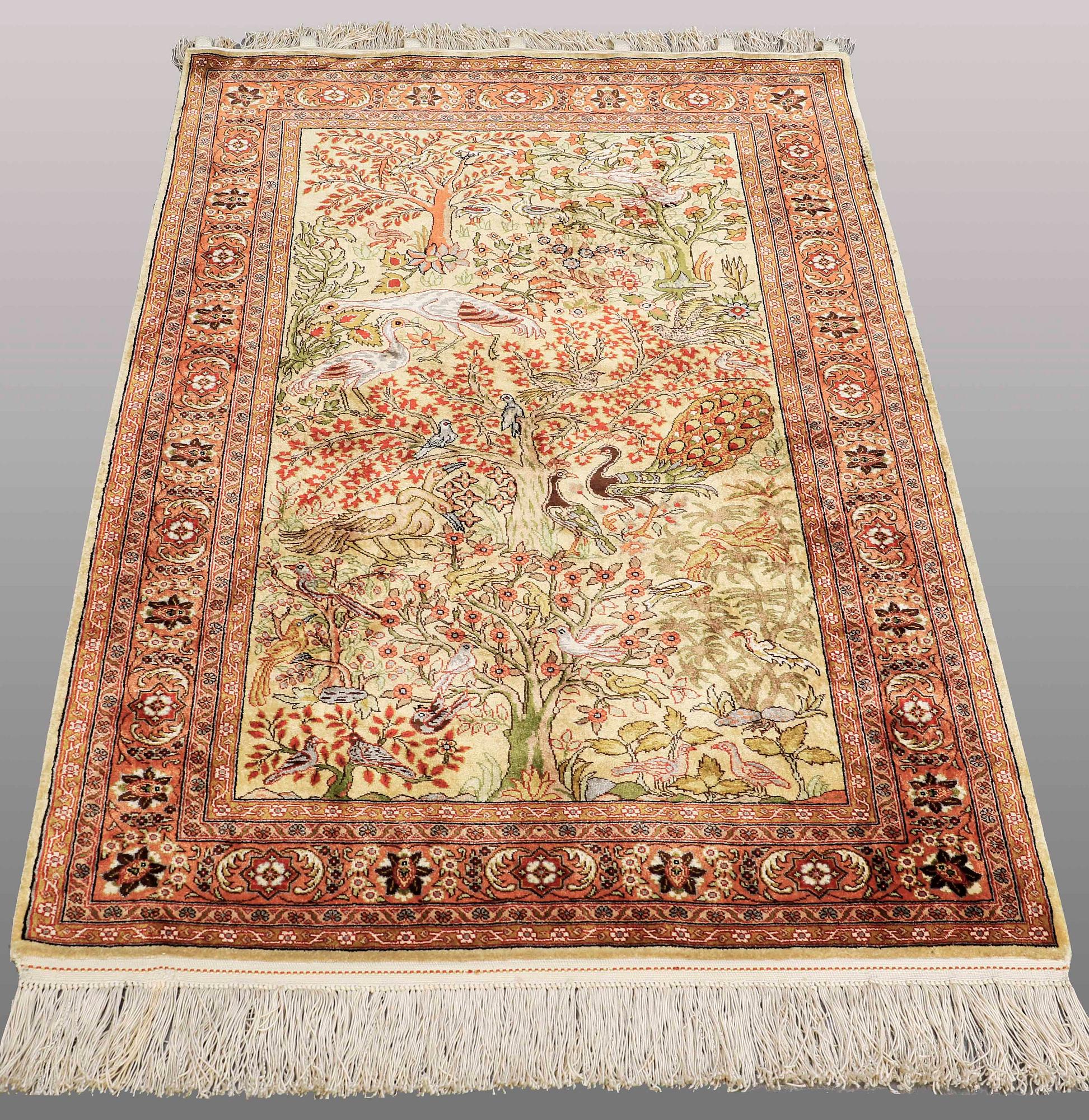 An Oriental figural silk rug, ca 126 x 83 cm.