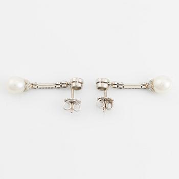 A pair of platinum pearl earings.