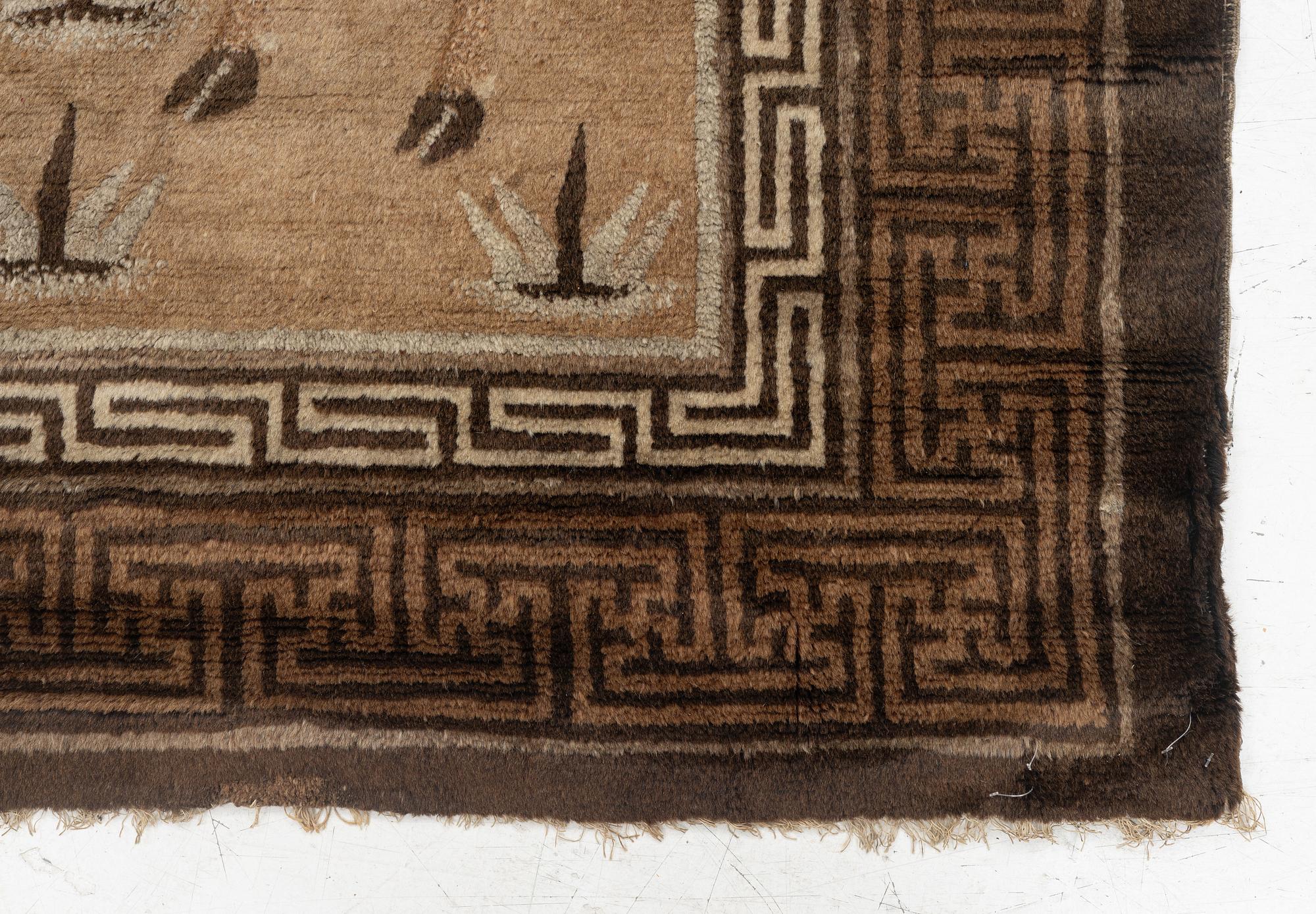 A figural semi-antique rug, China, c. 169 x 117 cm.