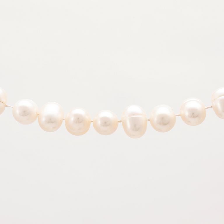 A cultured pearl necklace with a silver lock set with a round brilliant cut diamond.