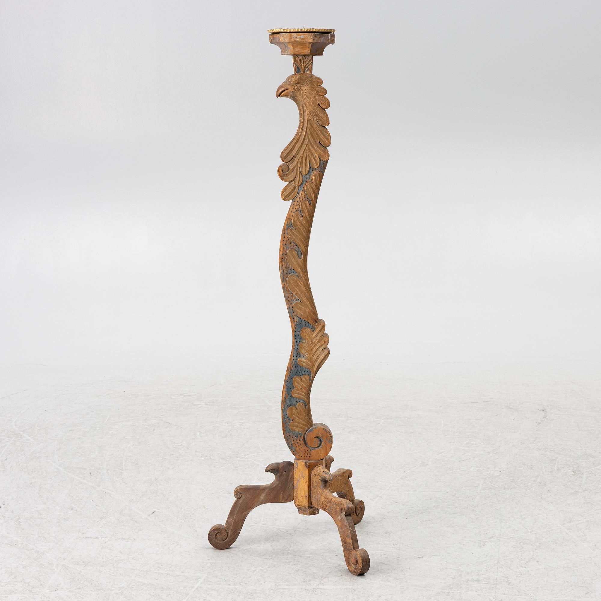 A carved wood floor candlestick, circa 1900 composed of 18th century elements.