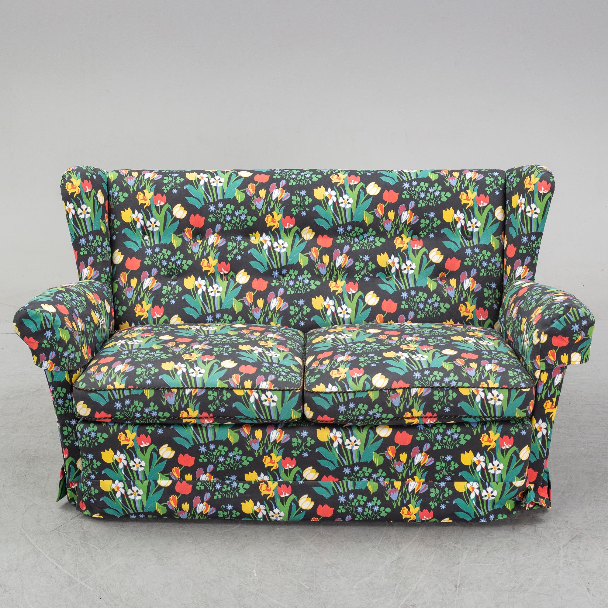 A sofa and wingback chair, later part of the 20th Century.