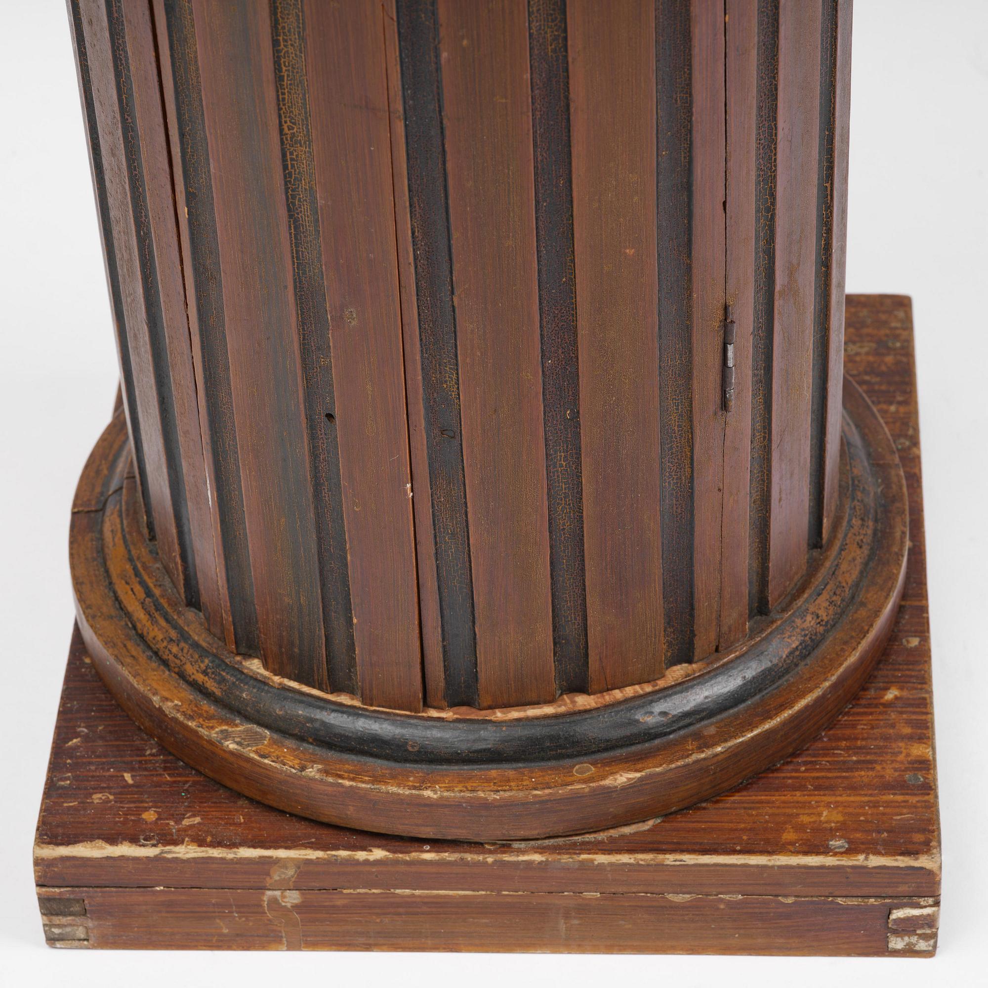 A Swedish Empire column-shaped cabinet, first part 19th century.