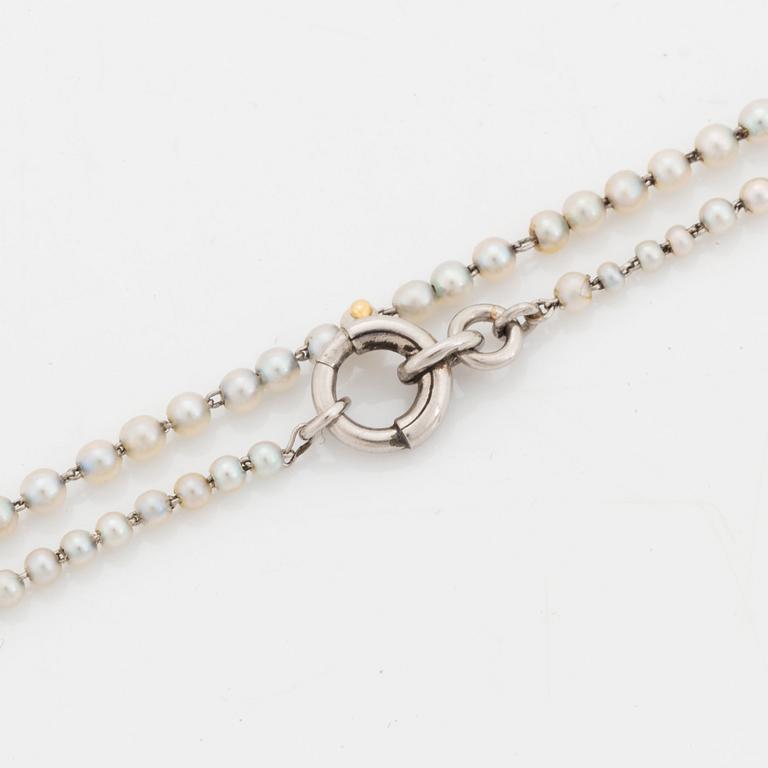 A platinum lorgnette set with a faceted sapphire and rose-cut diamonds.