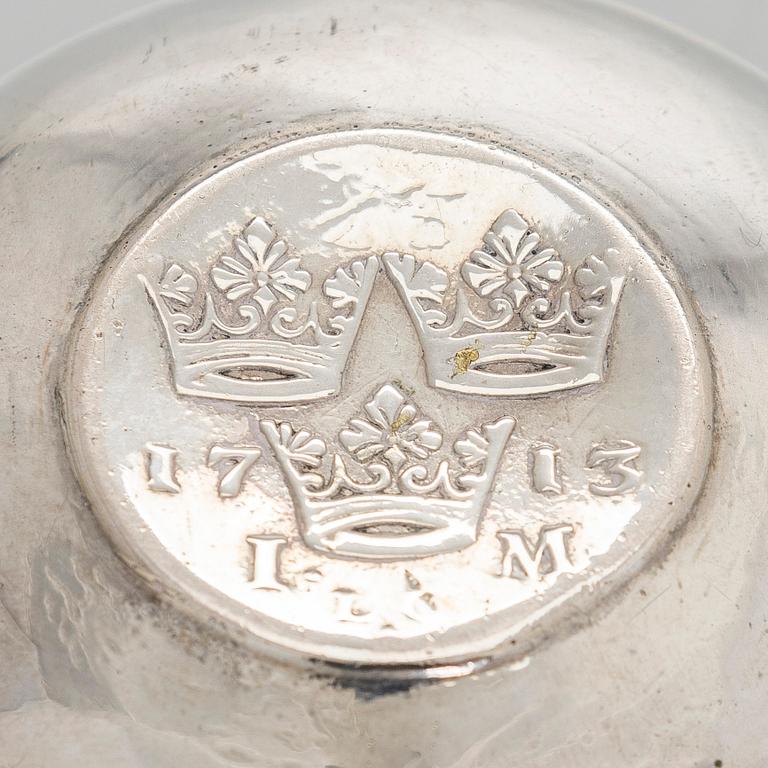 A silver tumbler with inset Swedish coin dated 1713.