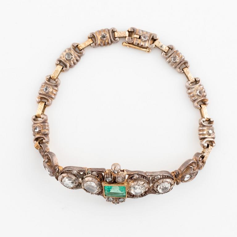 A 14K gold and silver bracelet set with an emerald and rose-cut diamonds.