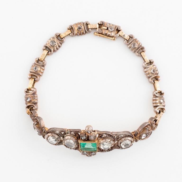 A 14K gold and silver bracelet set with an emerald and rose-cut diamonds.