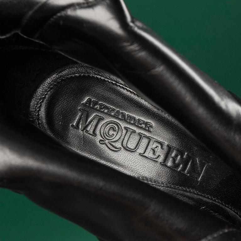 A pair of BOOTS by ALEXANDER MCQUEEN, in size 37.