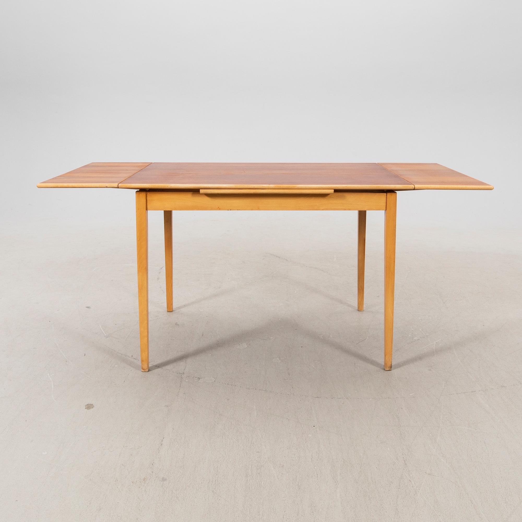 A 1960s teak and beech dining table.