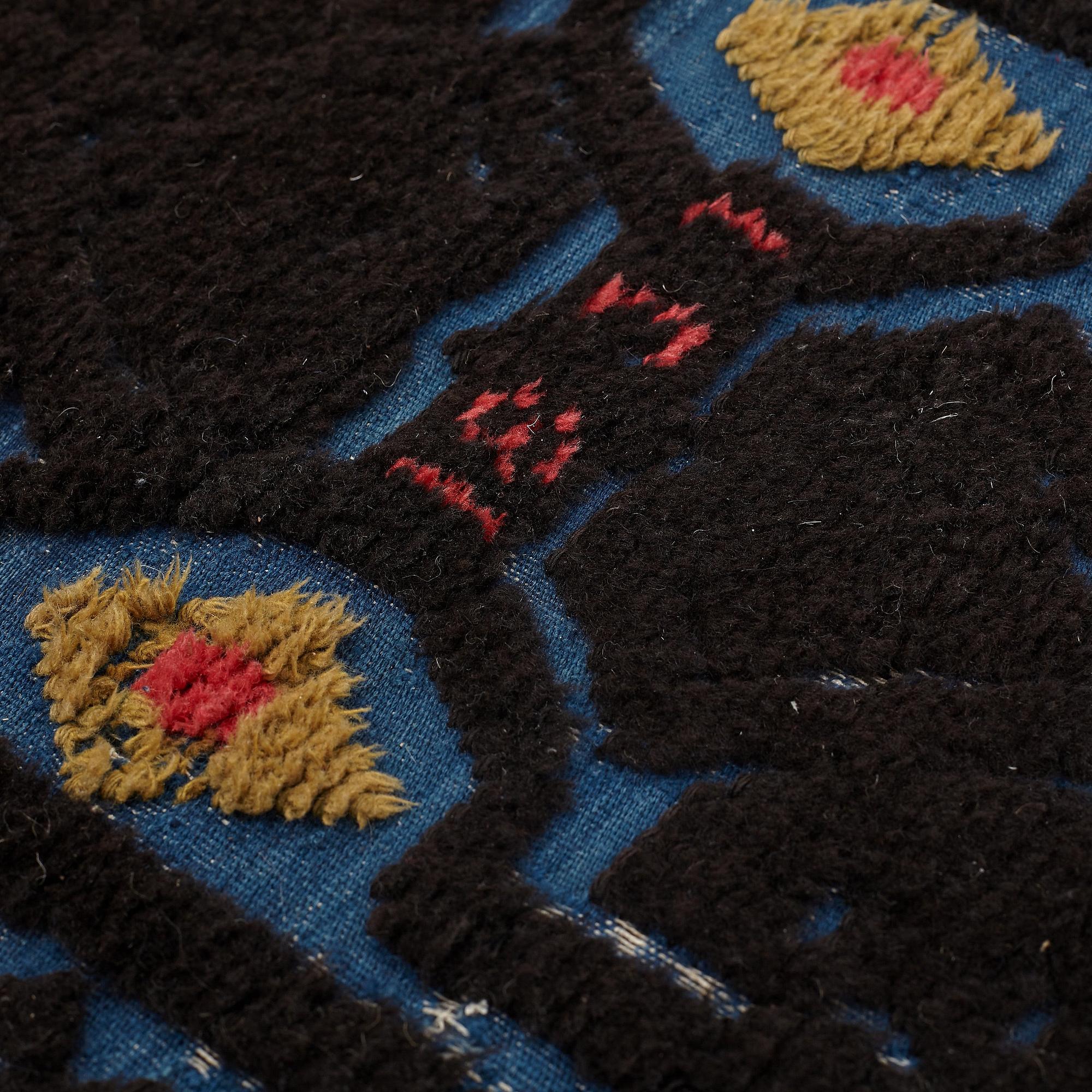 A carrige cushion, knotted pile in relief, ca 46,5 x 101 cm (with mounting 51 x 103,5 cm), probably Bara district,