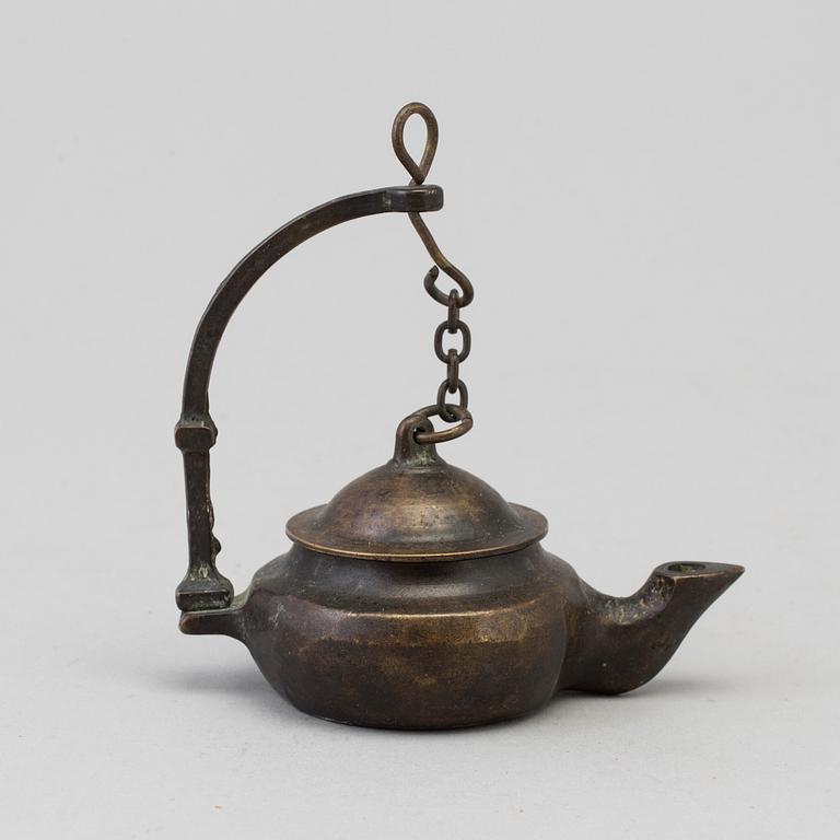 An 18th century bronze oil lamp.