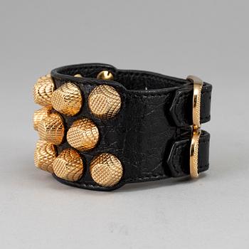 BALENCIAGA, a studded leather bracelet.