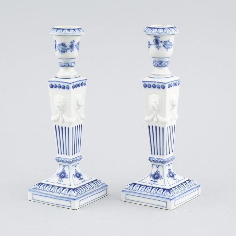 A pair of "Musselmalet" candlesticks in porcelain, by Royal Copenhagen, second half of the 20th century.