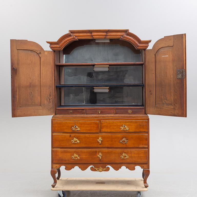 A mid 18th century rococo oak cabinet.