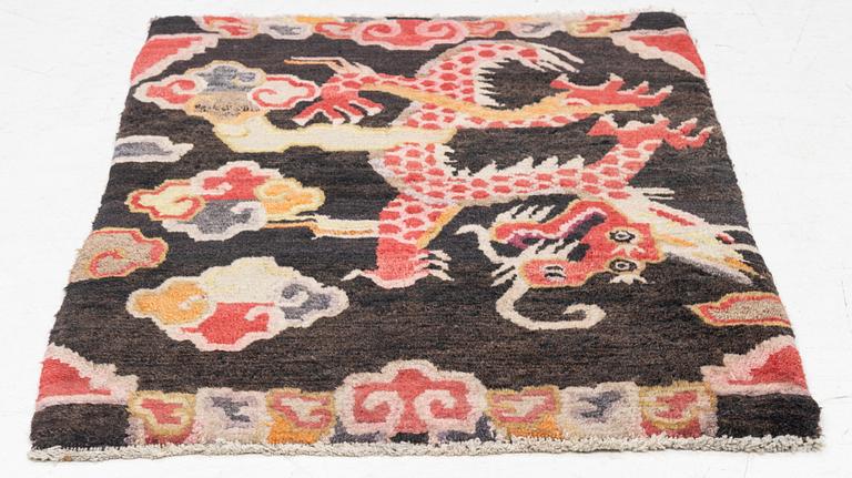 An semi-antique Tibet rug, 79 x 56 cm.