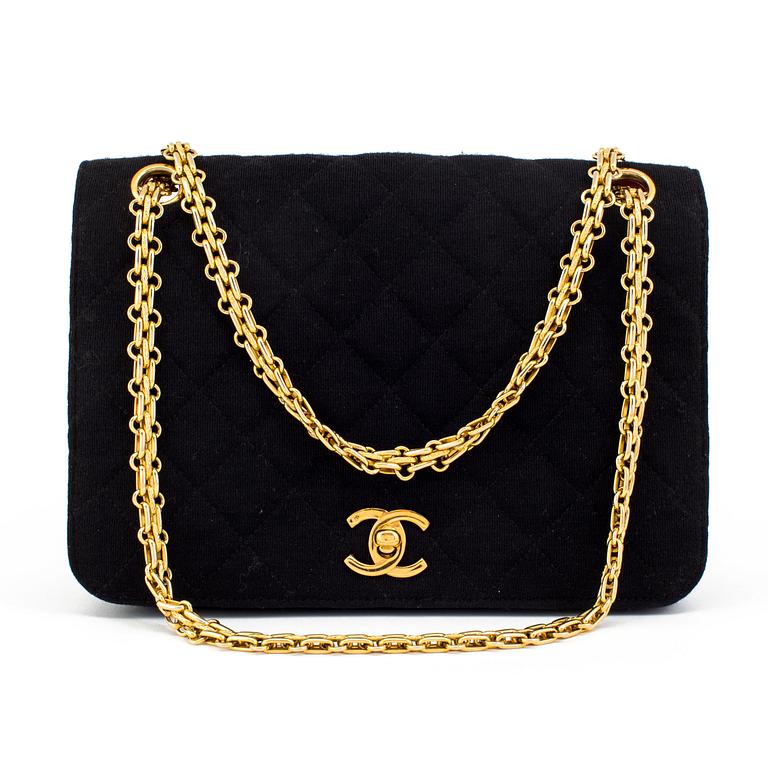 A black quiltet jersey handbag by Chanel.