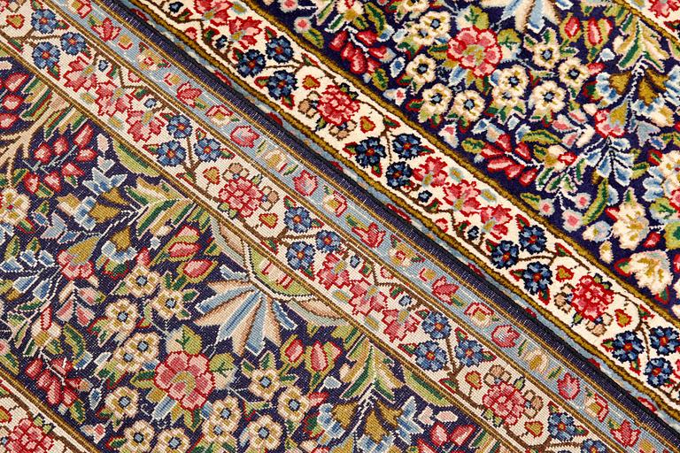 A Kirman Laver carpet, 'Millefleur', approx. 400 x 295 cm.