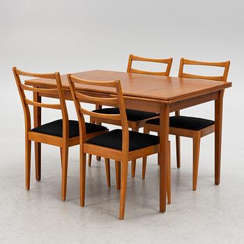 A dining table with four chairs, mid 20th century.