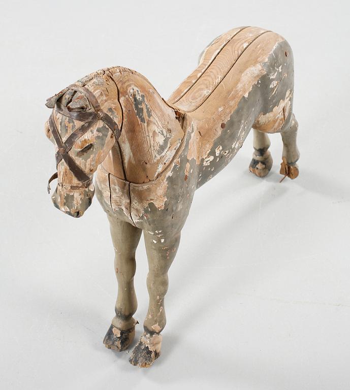 A wodden toy, made like a horse from the first half of the 20th century.