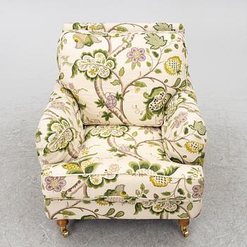 A 'Howard' armchair with footstool, Englesson.