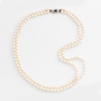 Necklace, double-stranded, cultured pearls, white gold clasp with sapphire and brilliant-cut diamonds.