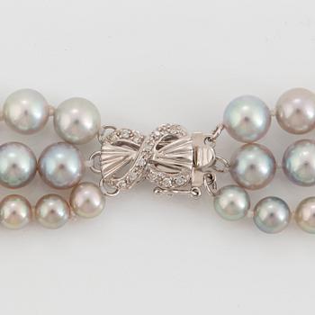 A three strand cultured pearl necklace.