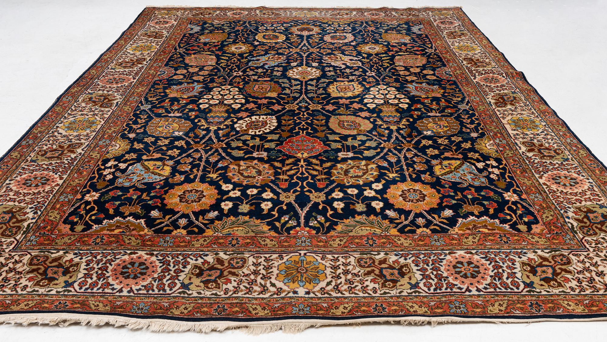 A semi-antique Tabriz carpet, c. 395 x 295 cm.