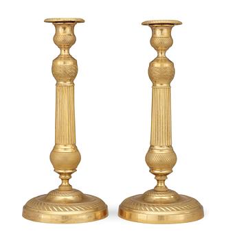 563. A pair of Empire candlesticks.