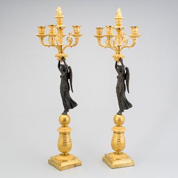 A large pair of first half of the 19th century gilt and patinated bronze five-light candelabra.