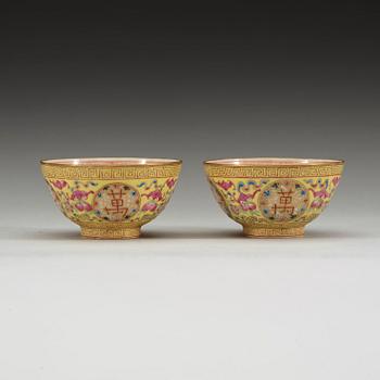 A pair of famille rose yellow ground cups, Qing dynasty, Guangxu six-character mark and of the period  (1875-1908).