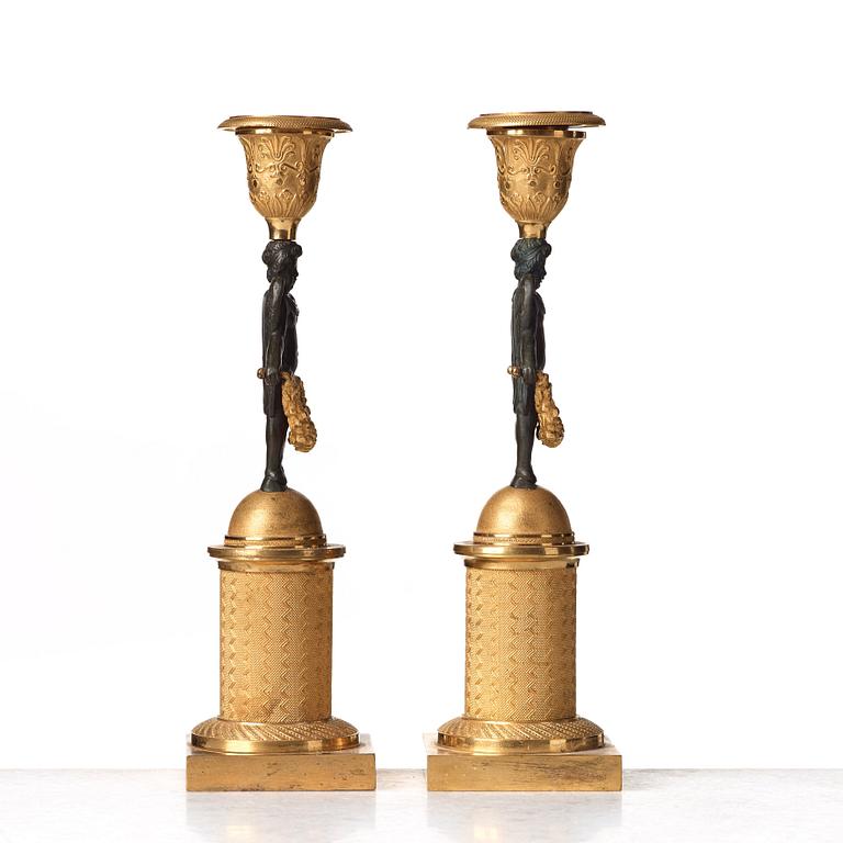 A pair of Empire early 19th century candlesticks.