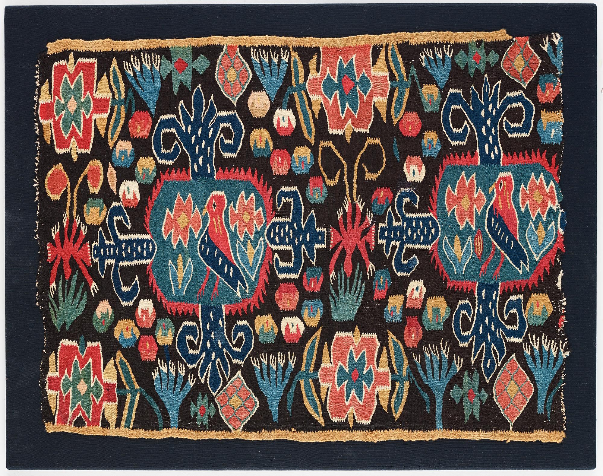 A CARRIAGE CUSHION FRAGMENT, tapestry weave, "Den innelykta fågeln", ca 52 x 67 cm, Scania (Sweden).
