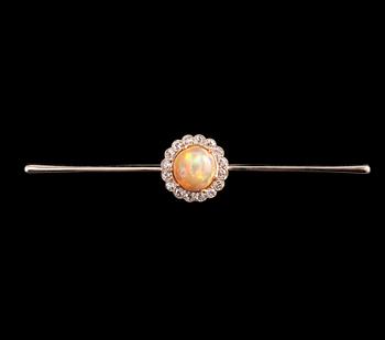 A BROOCH, Brilliant cut diamonds c. 0.65 ct, Opal 10 mm. 14K gold. Unmarked. Length 85 mm, weight 8,2 g.