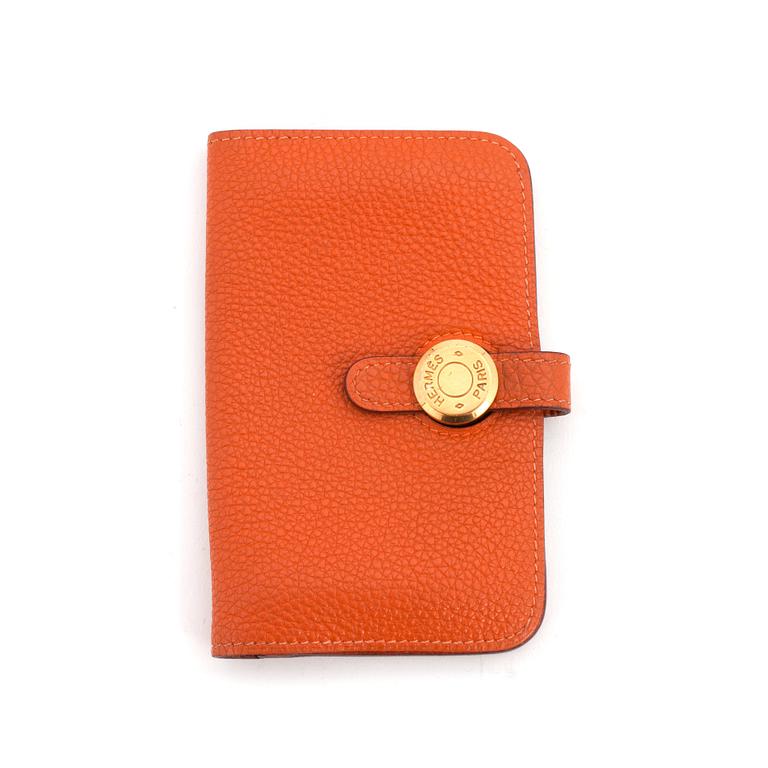 HERMÈS, a orange leather key holder.