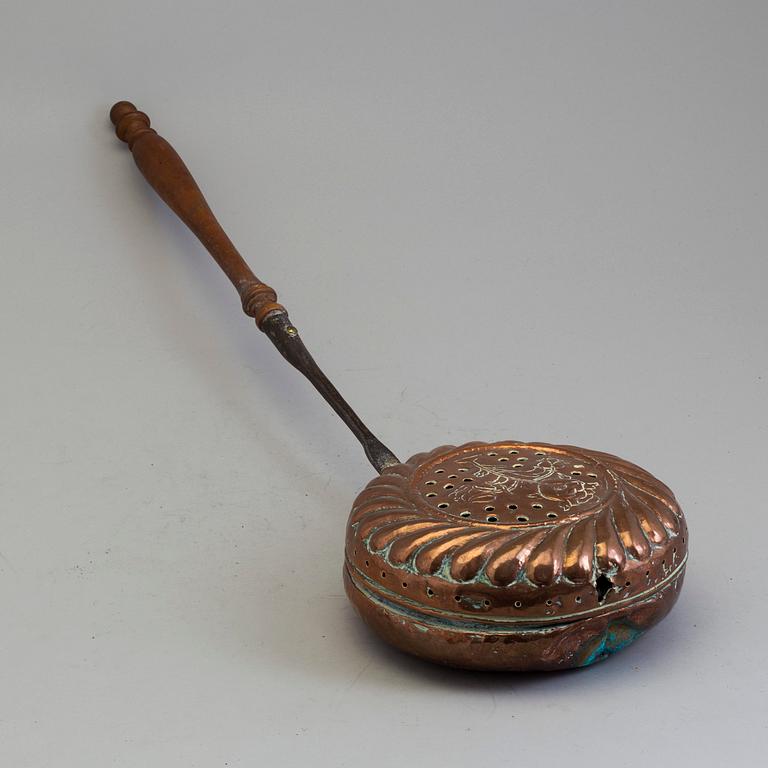 A 18th century copper bed warmer.