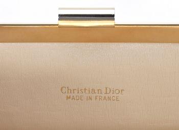 A white monogram canvas clutch by Christian Dior.