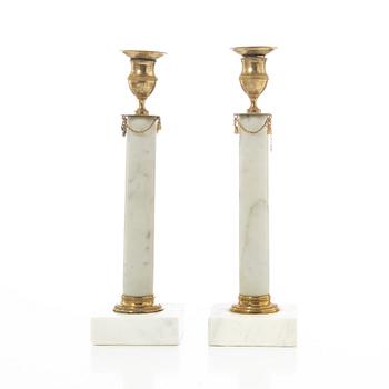 A pair of late Gustavian gilt brass and marble candlesticks, circa 1800.