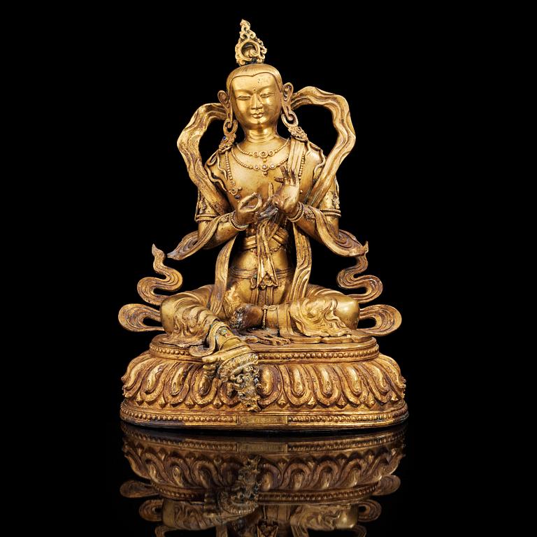 A large gilt bronze figure of Tara, with Qianlong mark.