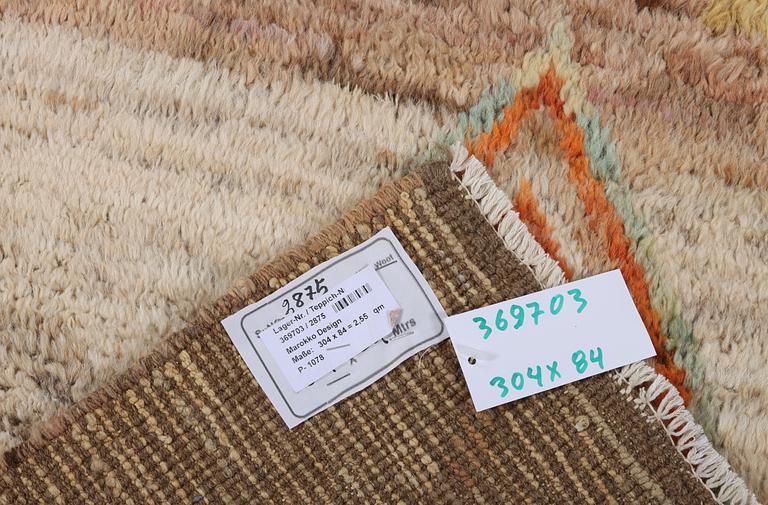 A Moroccan runner carpet, c. 304 x 84 cm.