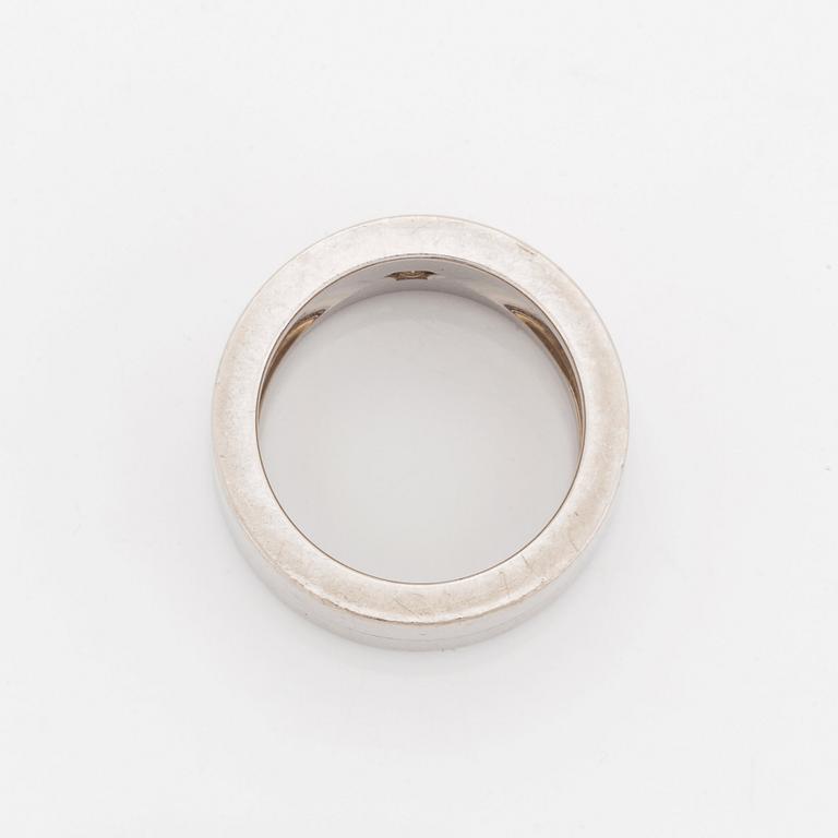 A Cartier 18K white gold ring set with a round brilliant-cut diamond.