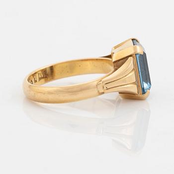 18K gold and synthetic blue spinel ring.