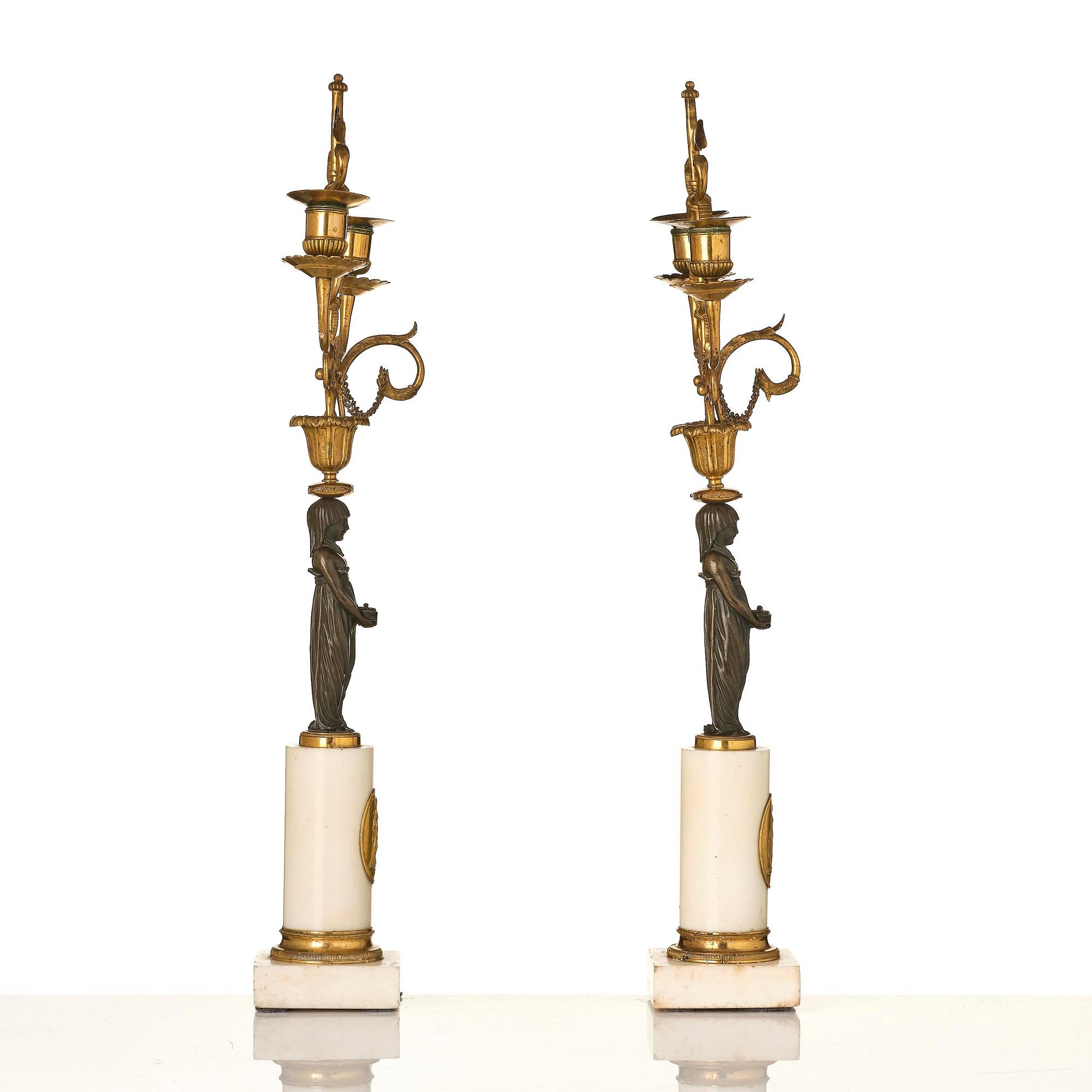 A pair of late Gustavian white marble and bronze candelabra.