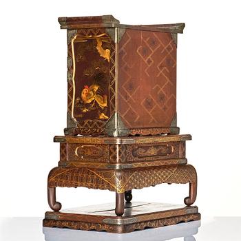 A Japanese lacquer cabinet on a stand, Meiji period (1868-1912).