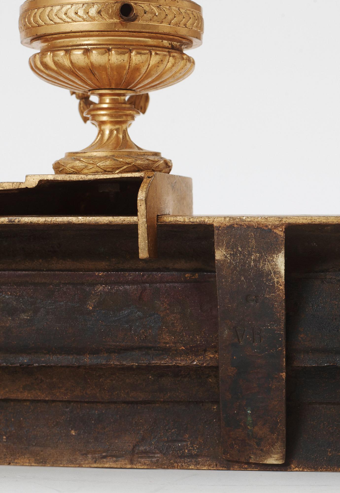 A pair of French Louis XVI-style 19th century gilt bronze fire dogs.