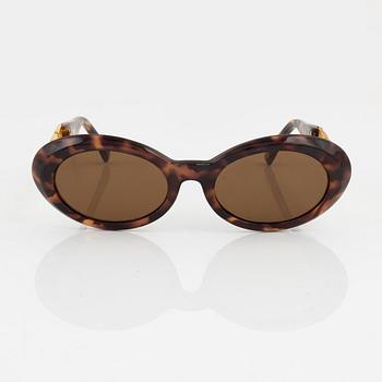 Gianni Versace, a pair of brown and gold sunglasses.